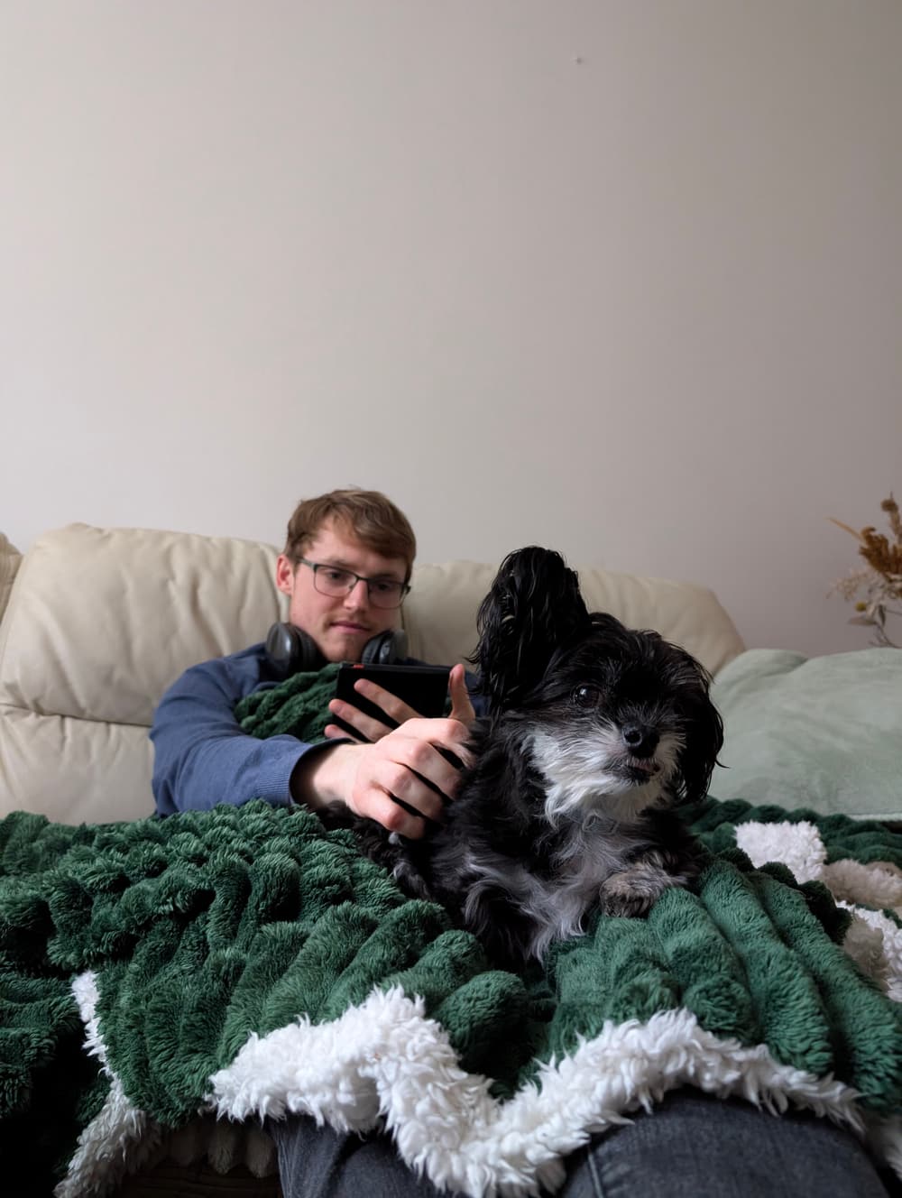 Aaron on an overnight pet sit, relaxing on the sofa with a small dog